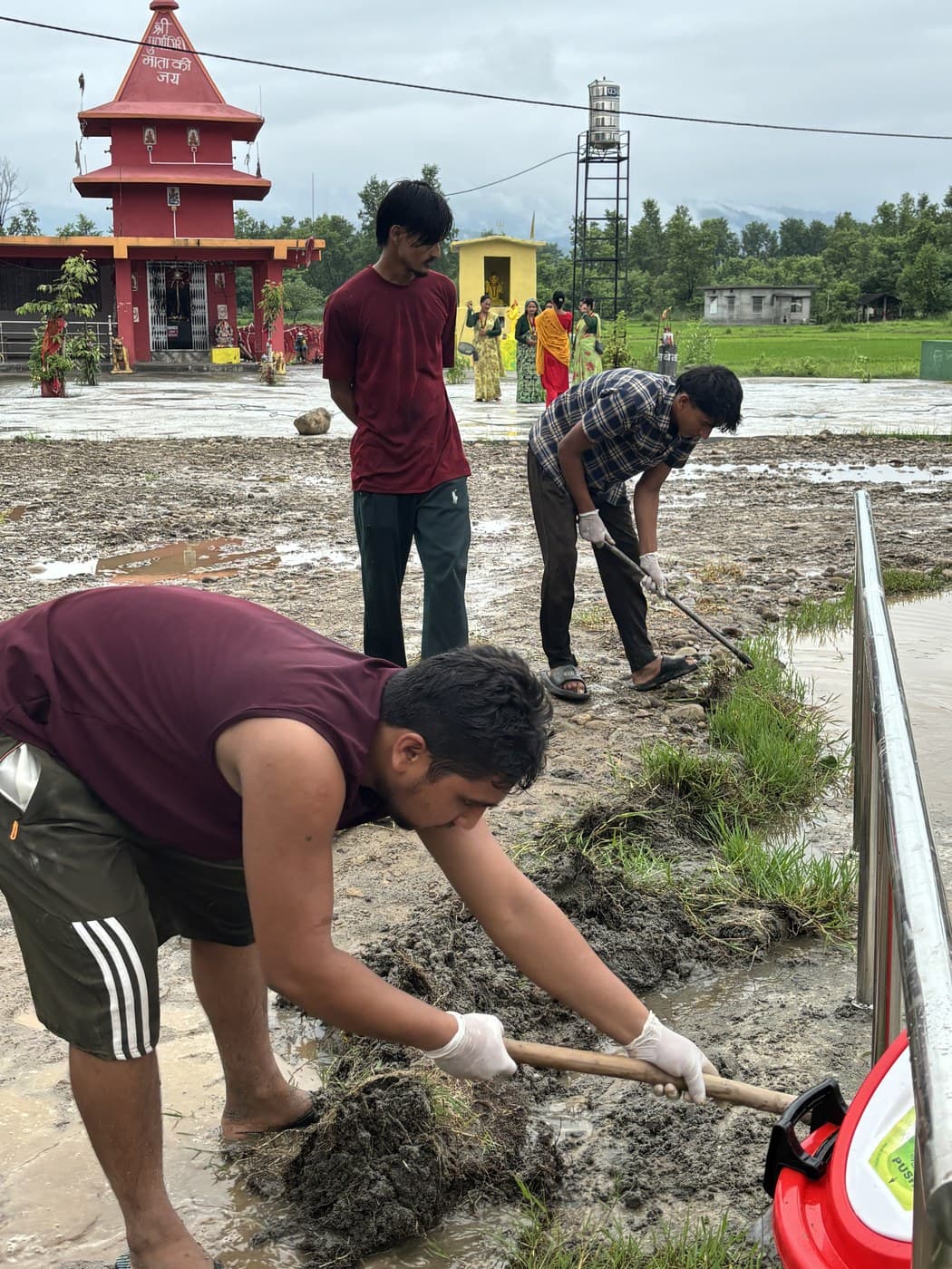 Clearing mud from the temple yard